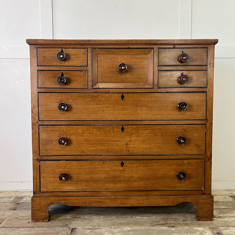A large Victorian scumble painted pine chest of drawers featuring five graduated drawers and turned wooden knobs. View II