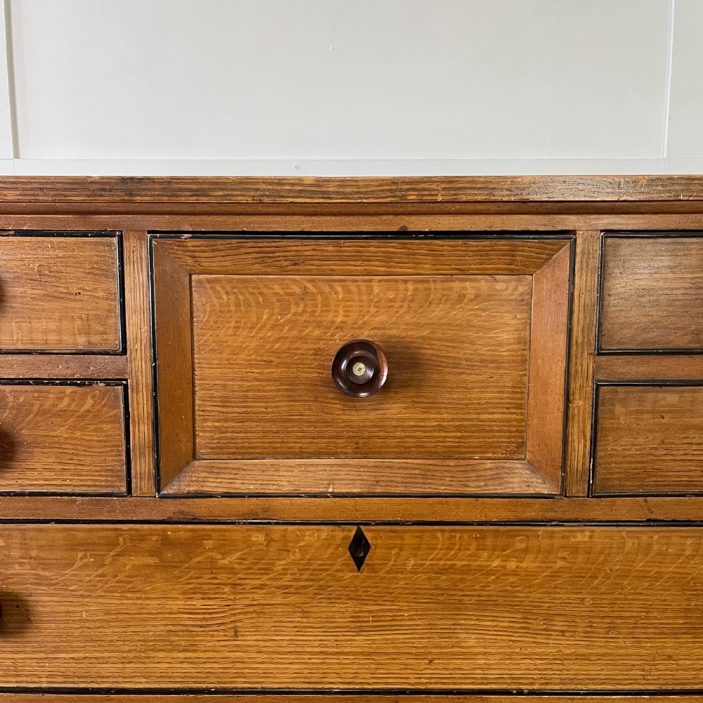 A large Victorian scumble painted pine chest of drawers featuring five graduated drawers and turned wooden knobs. View III