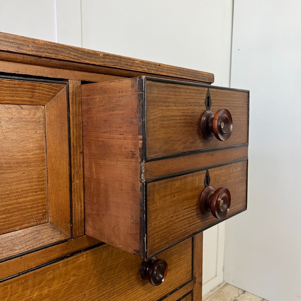 A large Victorian scumble painted pine chest of drawers featuring five graduated drawers and turned wooden knobs. View VI