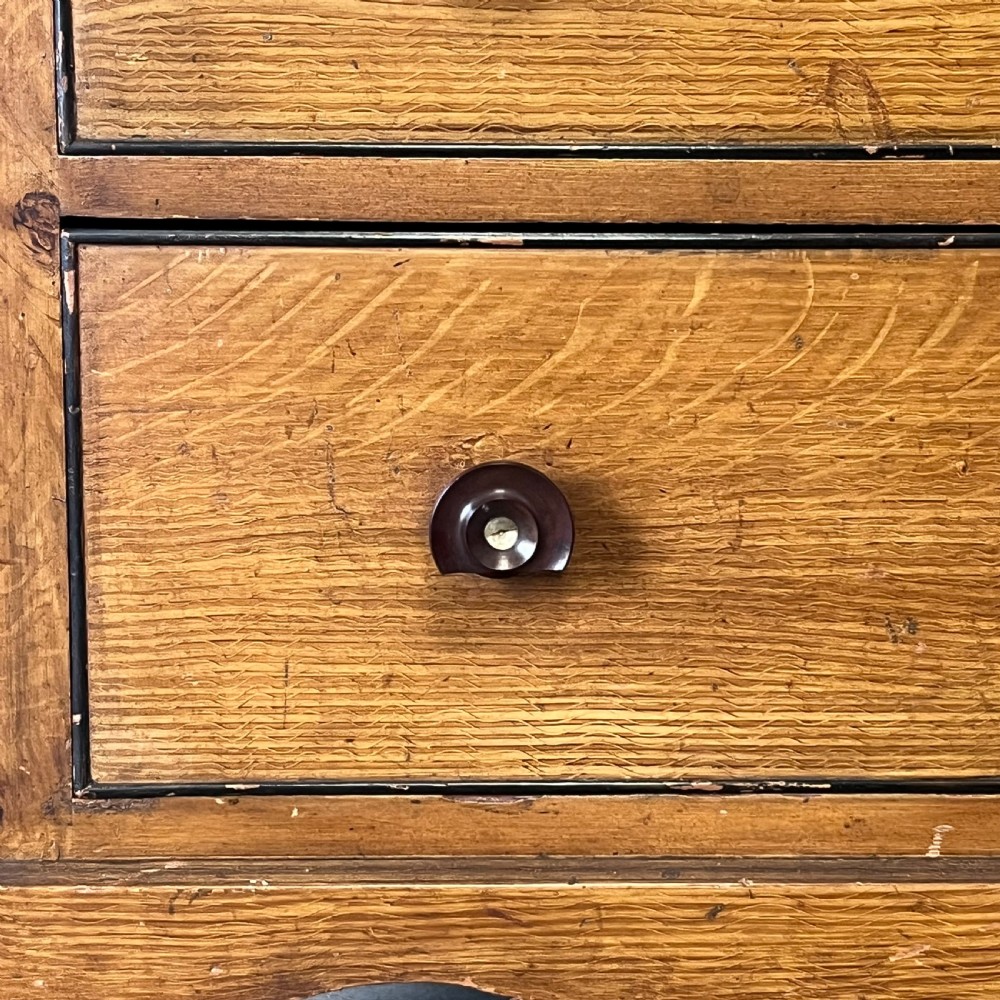 A large Victorian scumble painted pine chest of drawers featuring five graduated drawers and turned wooden knobs. View VII