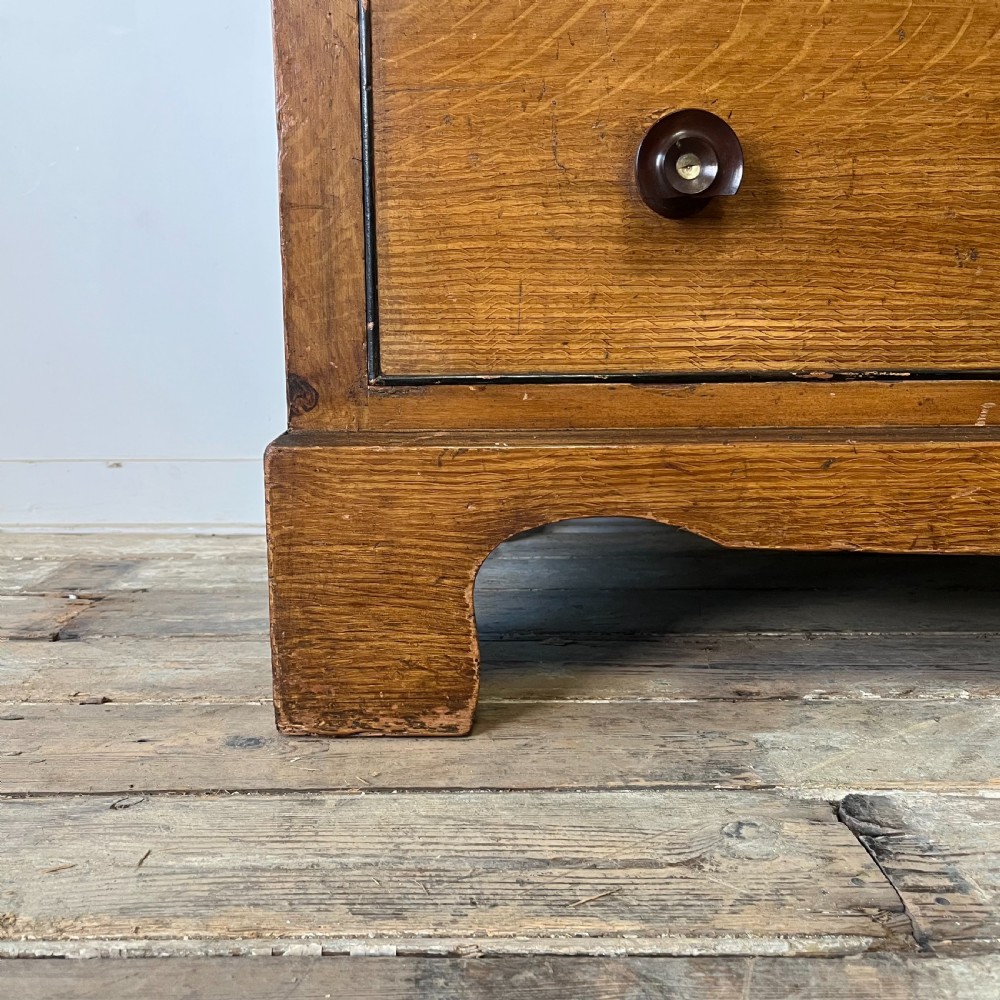 A large Victorian scumble painted pine chest of drawers featuring five graduated drawers and turned wooden knobs. View IX