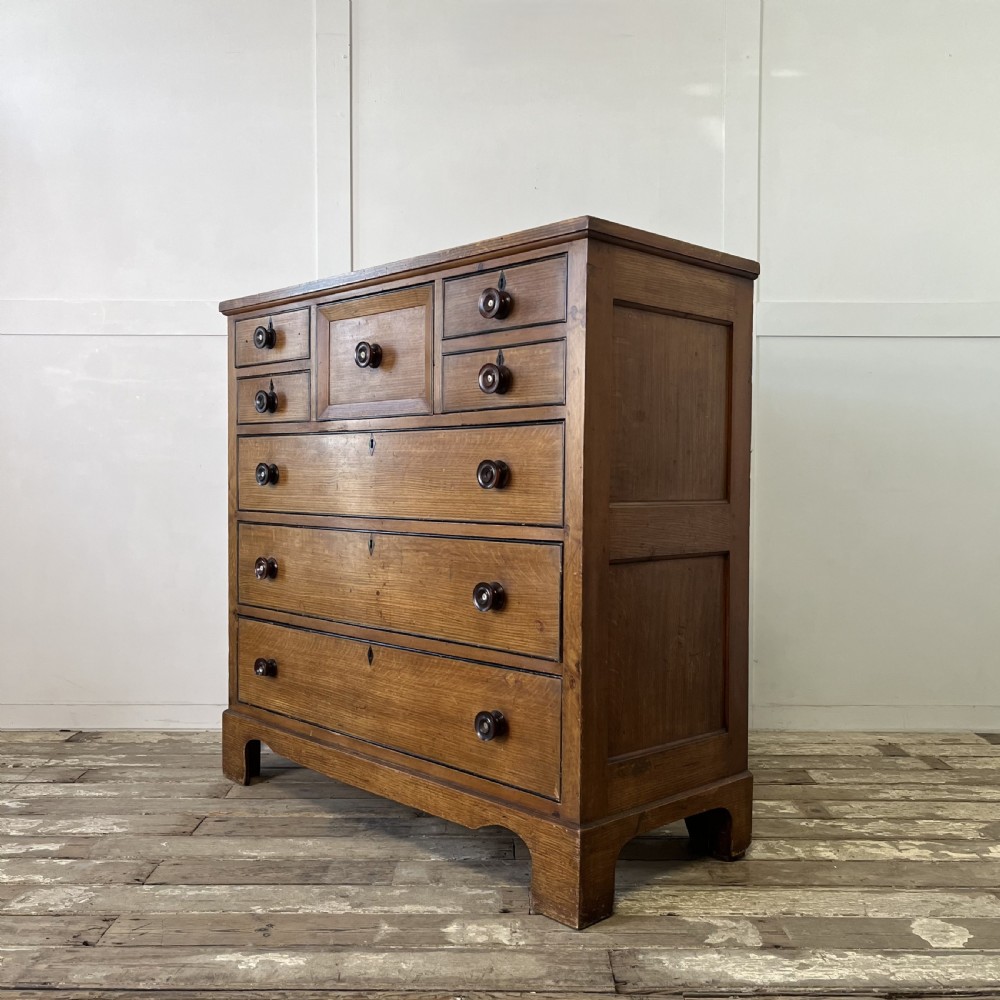 A large Victorian scumble painted pine chest of drawers featuring five graduated drawers and turned wooden knobs. View XV