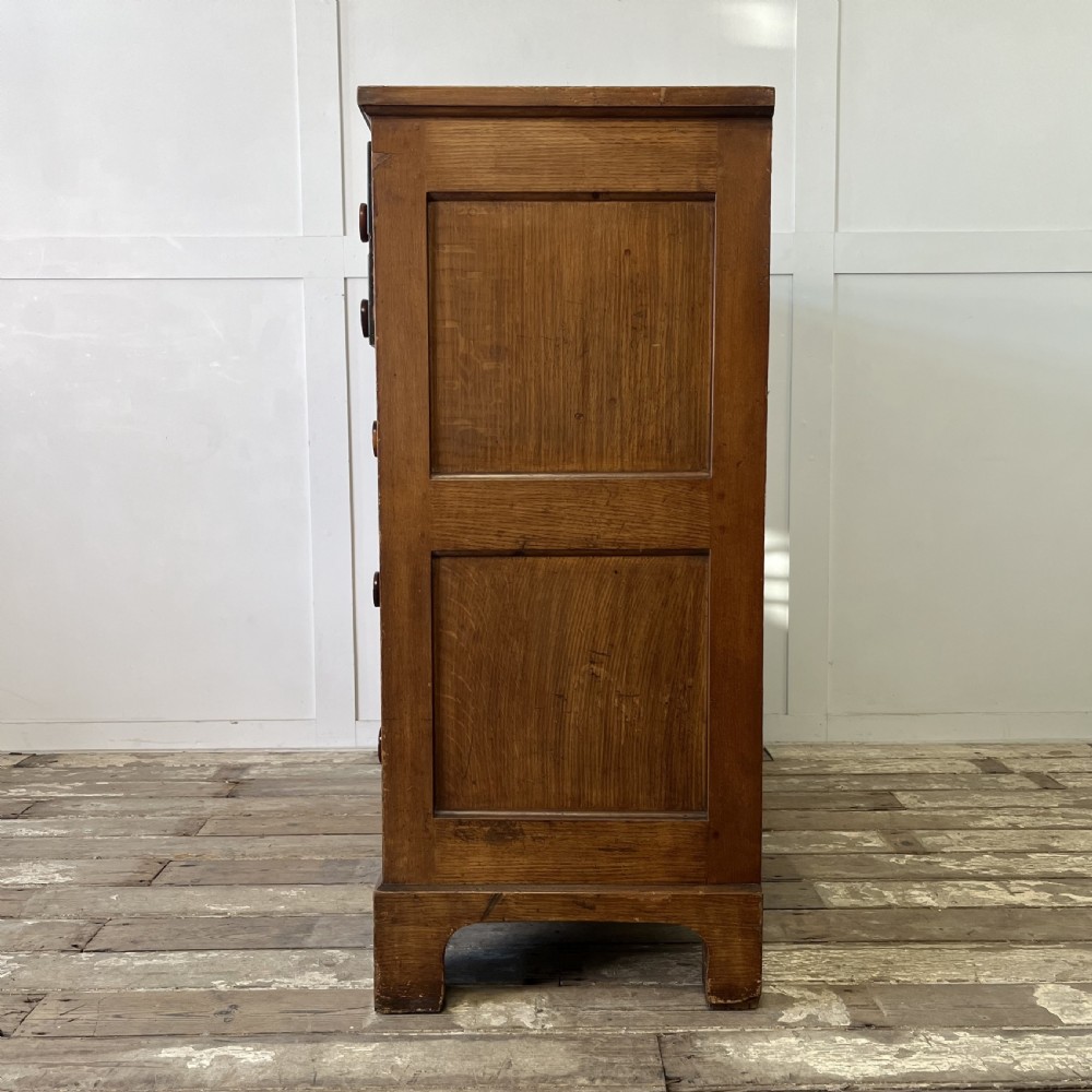 A large Victorian scumble painted pine chest of drawers featuring five graduated drawers and turned wooden knobs. View XVI