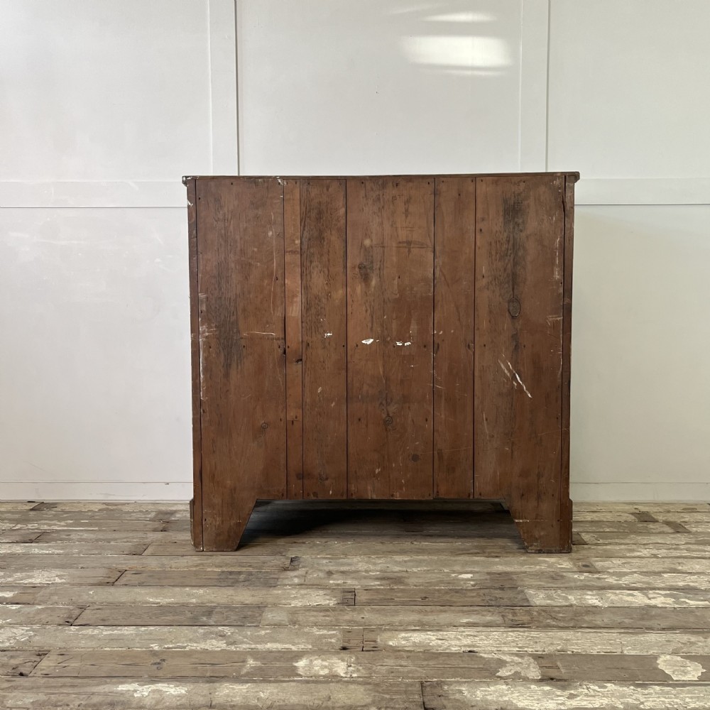 A large Victorian scumble painted pine chest of drawers featuring five graduated drawers and turned wooden knobs. View XIX