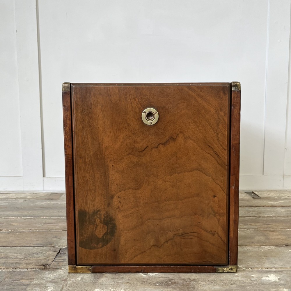 A nineteenth-century rectangular wooden desktop campaign chest featuring two drawers, flush brass drop handles, and brass corner straps. View II