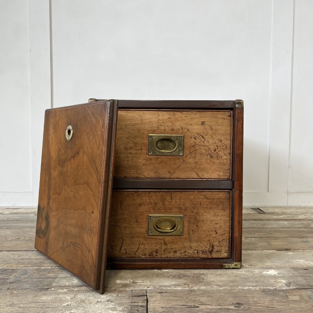 A nineteenth-century rectangular wooden desktop campaign chest featuring two drawers, flush brass drop handles, and brass corner straps. View III