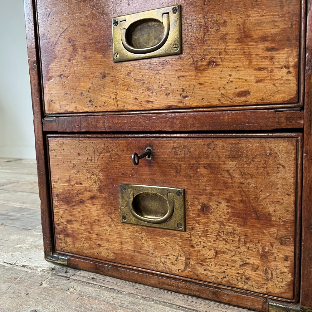 A nineteenth-century rectangular wooden desktop campaign chest featuring two drawers, flush brass drop handles, and brass corner straps. View IX