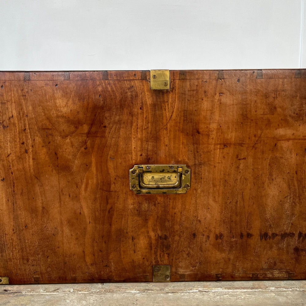 A nineteenth-century rectangular wooden desktop campaign chest featuring two drawers, flush brass drop handles, and brass corner straps. View X