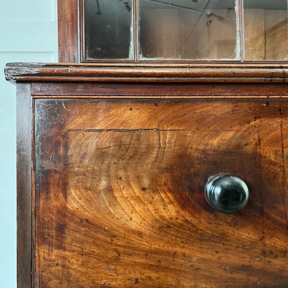 A dark mahogany George III secretaire bookcase featuring upper astragal glazed doors, a fold-out secretaire desk section with green leather insert, and lower cupboard doors on bracket feet. View XI