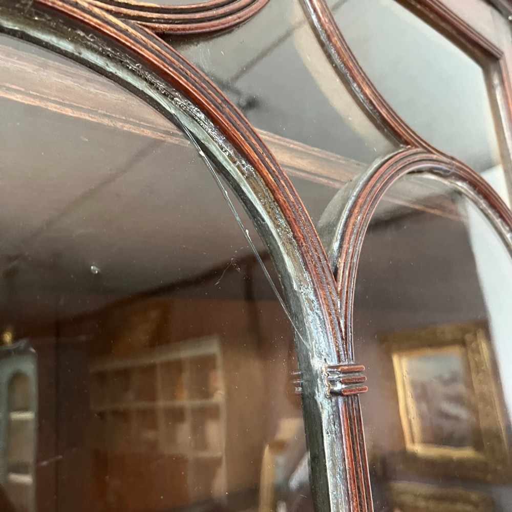 A dark mahogany George III secretaire bookcase featuring upper astragal glazed doors, a fold-out secretaire desk section with green leather insert, and lower cupboard doors on bracket feet. View XV