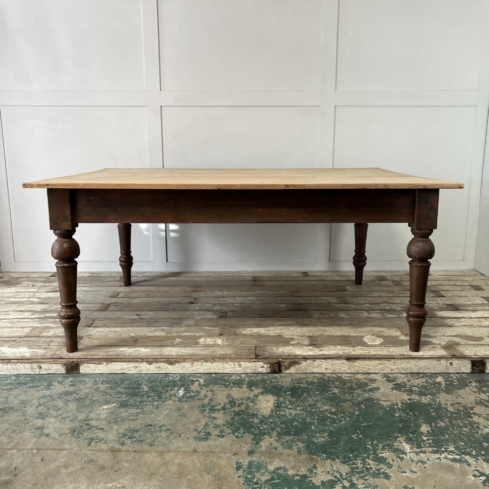 A large Victorian pine farmhouse table featuring a light natural wood plank top supported by dark brown turned wooden legs. View II