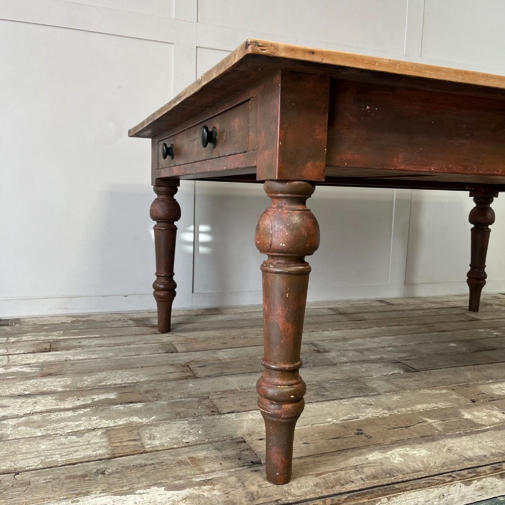 A large Victorian pine farmhouse table featuring a light natural wood plank top supported by dark brown turned wooden legs. View III