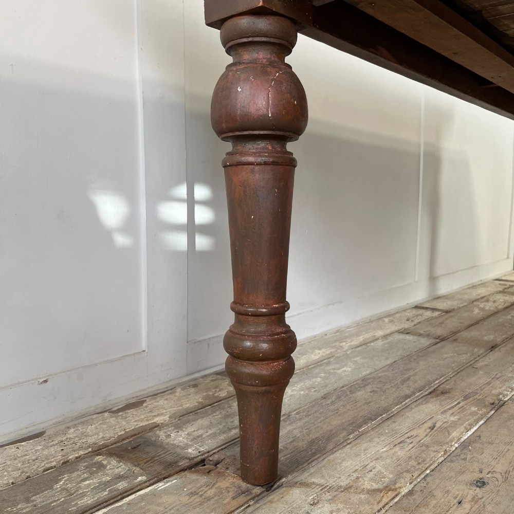 A large Victorian pine farmhouse table featuring a light natural wood plank top supported by dark brown turned wooden legs. View IV