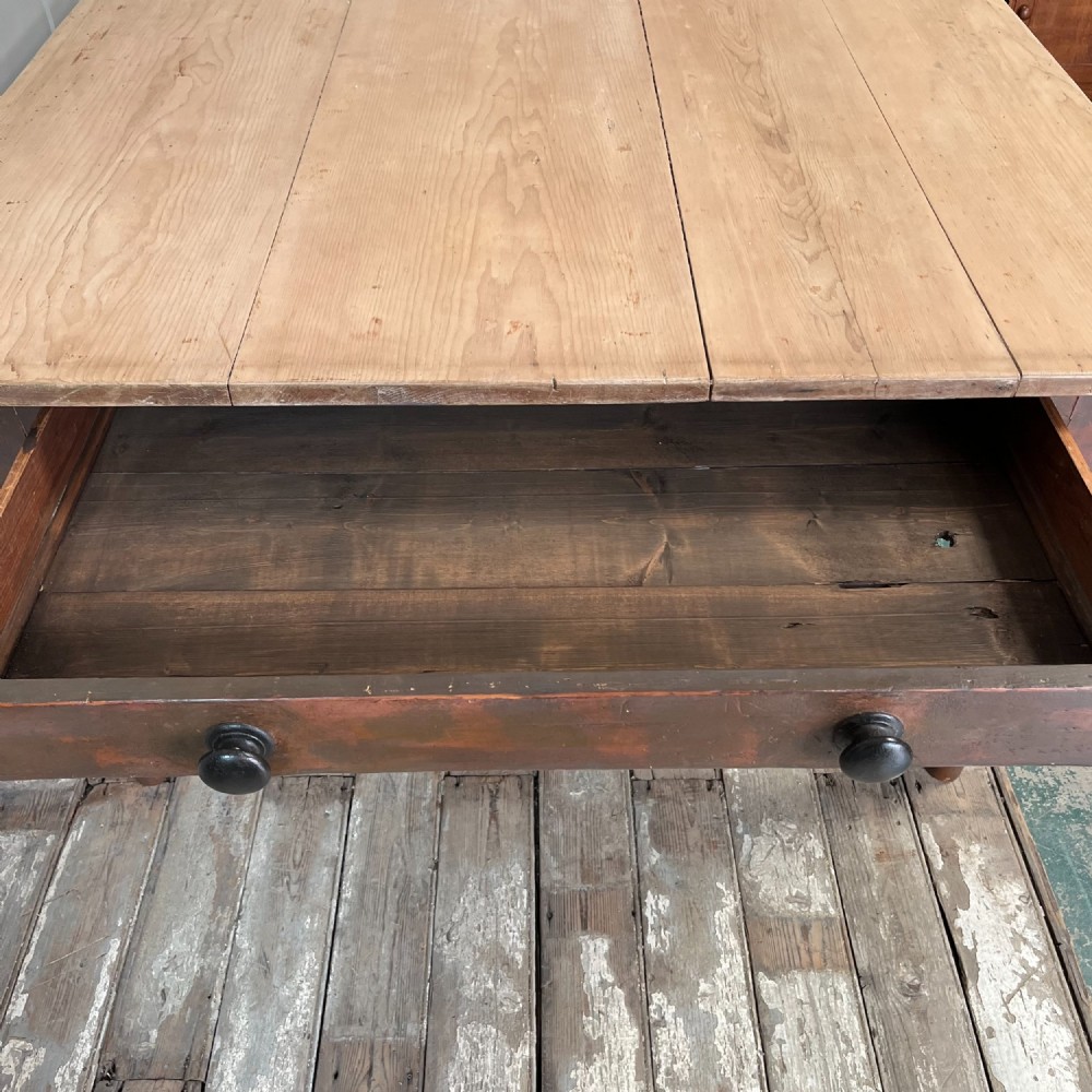 A large Victorian pine farmhouse table featuring a light natural wood plank top supported by dark brown turned wooden legs. View V
