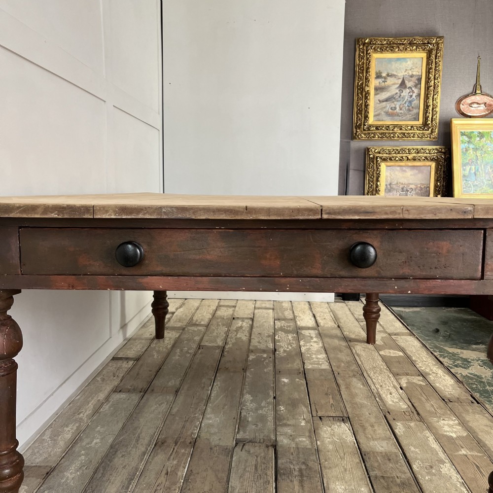 A large Victorian pine farmhouse table featuring a light natural wood plank top supported by dark brown turned wooden legs. View VI