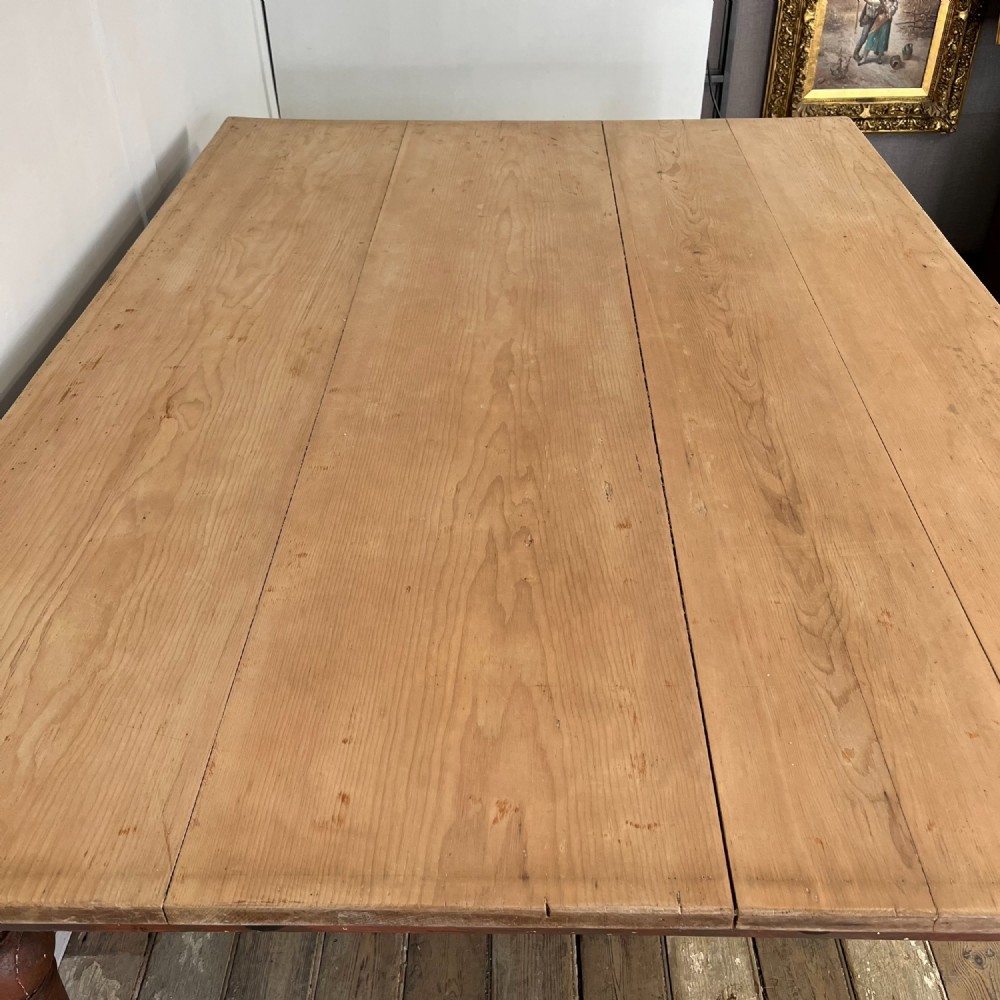 A large Victorian pine farmhouse table featuring a light natural wood plank top supported by dark brown turned wooden legs. View VII
