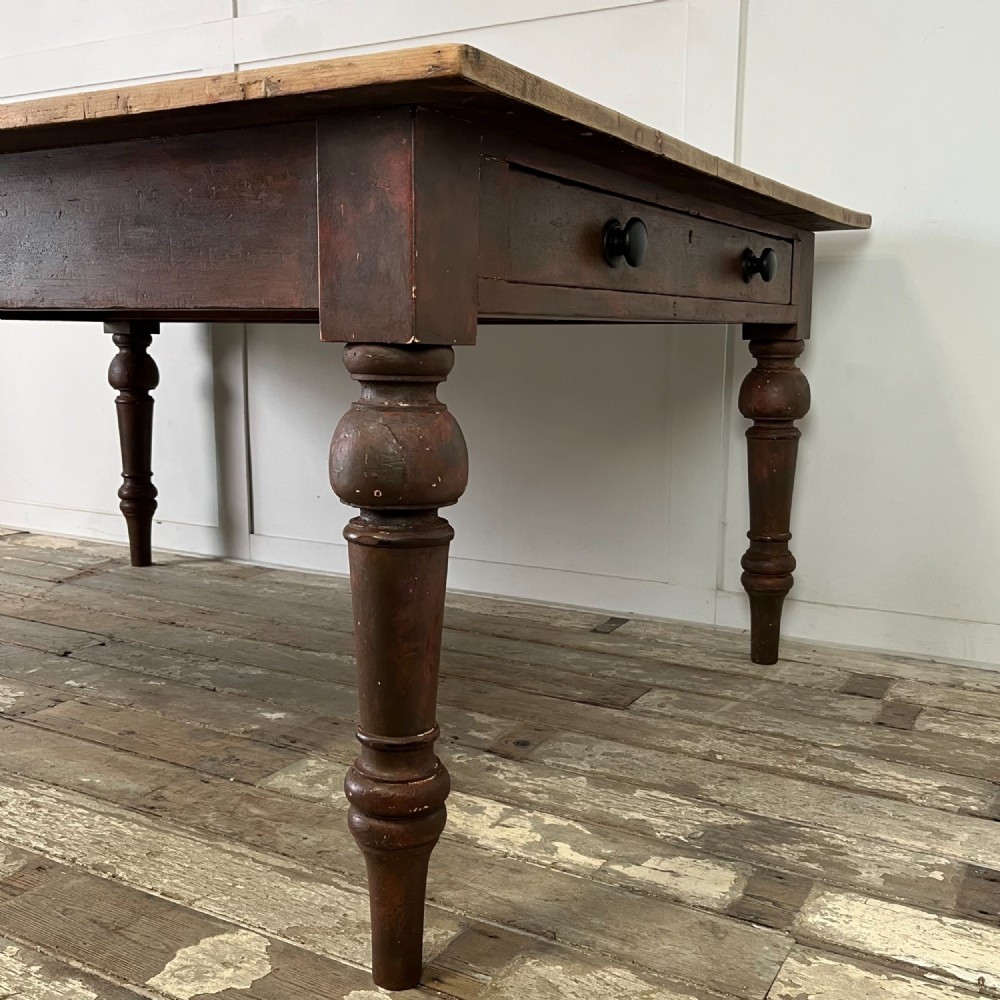 A large Victorian pine farmhouse table featuring a light natural wood plank top supported by dark brown turned wooden legs. View VIII