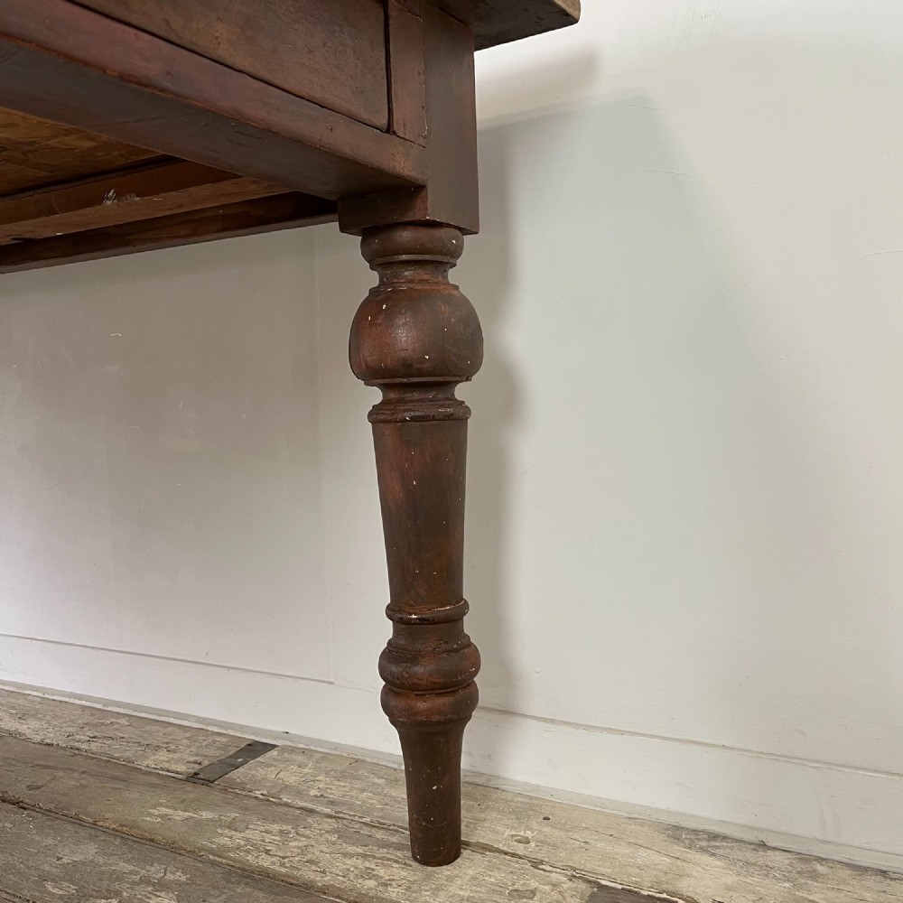 A large Victorian pine farmhouse table featuring a light natural wood plank top supported by dark brown turned wooden legs. View IX