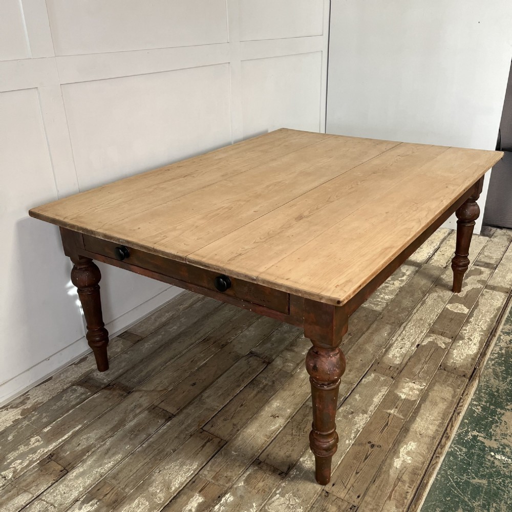 A large Victorian pine farmhouse table featuring a light natural wood plank top supported by dark brown turned wooden legs. View XII