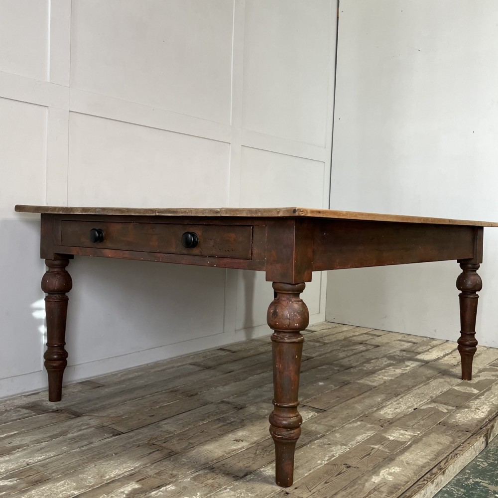 A large Victorian pine farmhouse table featuring a light natural wood plank top supported by dark brown turned wooden legs. View XIII