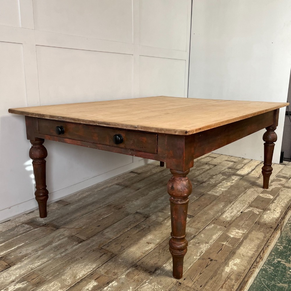 A large Victorian pine farmhouse table featuring a light natural wood plank top supported by dark brown turned wooden legs. View XIV