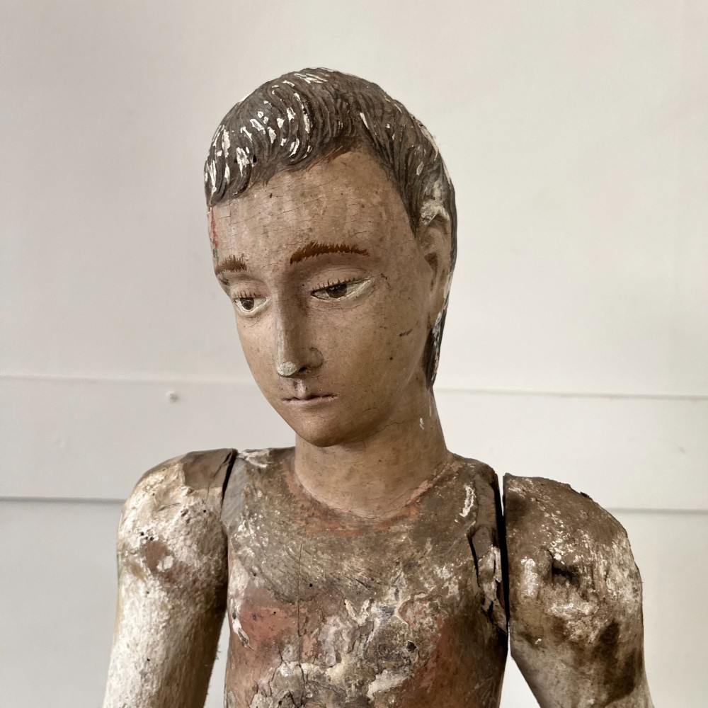 An 18th-century Spanish capipote featuring a carved wooden polychrome head and torso mounted on a tall wooden tripod cage frame. View III