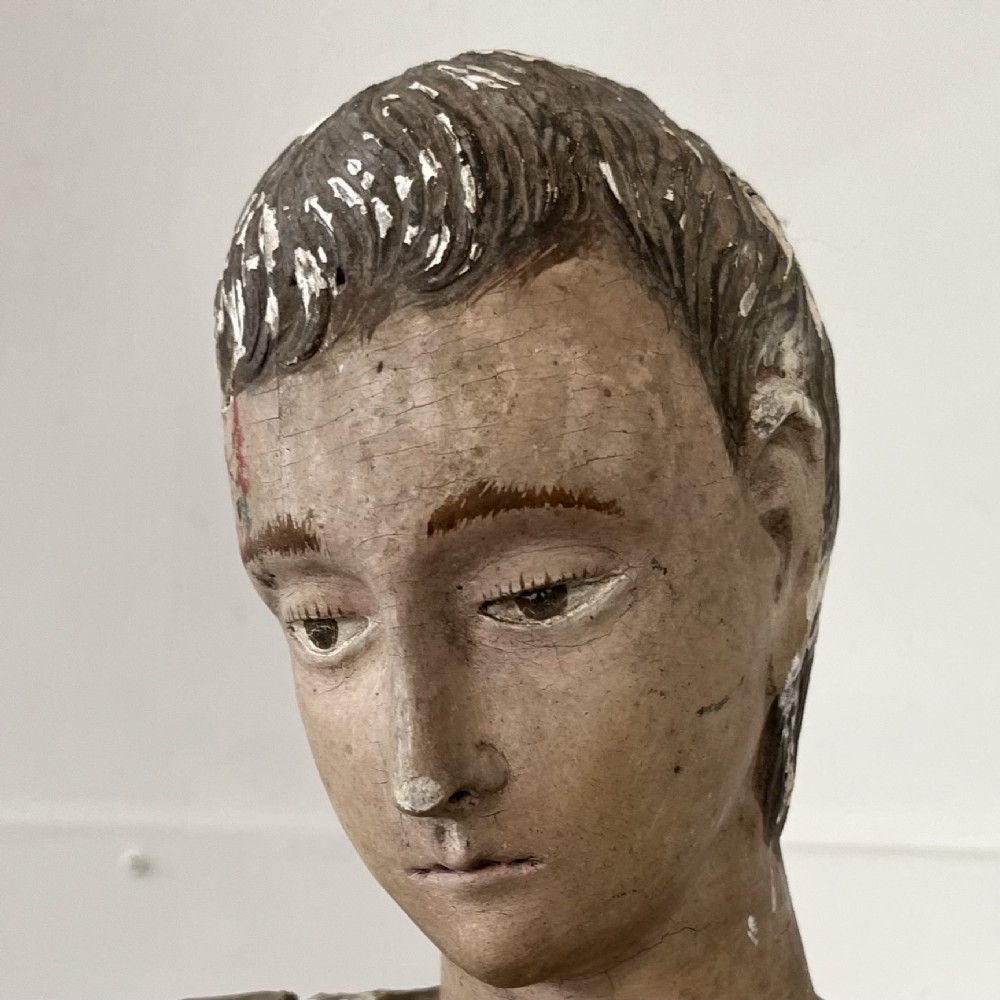 An 18th-century Spanish capipote featuring a carved wooden polychrome head and torso mounted on a tall wooden tripod cage frame. View IV