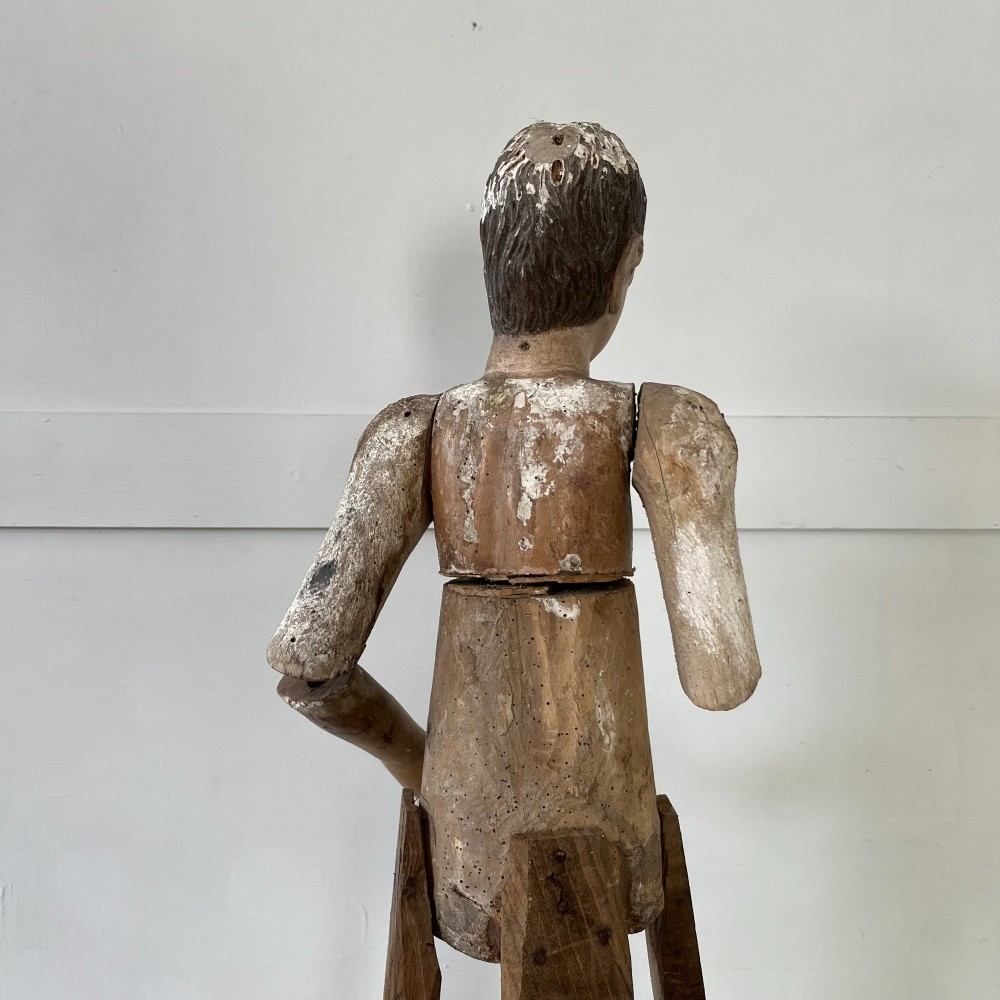 An 18th-century Spanish capipote featuring a carved wooden polychrome head and torso mounted on a tall wooden tripod cage frame. View VI