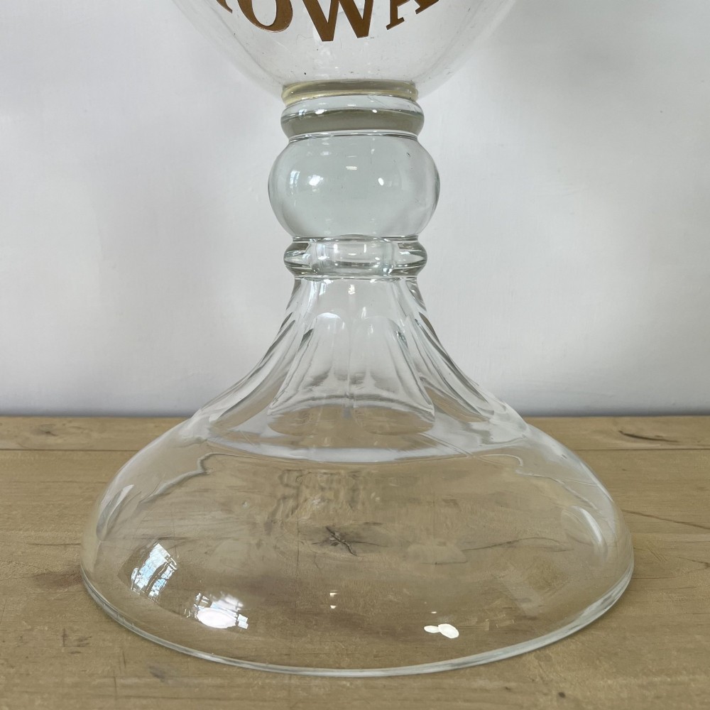 A clear cut glass Edwardian apothecary jar with a pointed finial lid, lattice shoulder pattern, and printed crest above the text ROWAN. View II