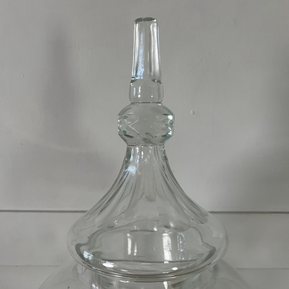 A clear cut glass Edwardian apothecary jar with a pointed finial lid, lattice shoulder pattern, and printed crest above the text ROWAN. View V