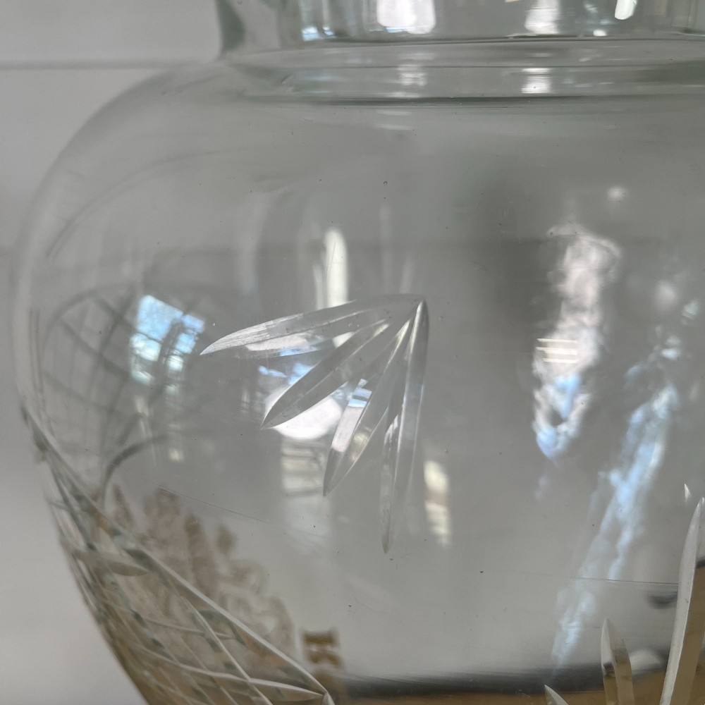 A clear cut glass Edwardian apothecary jar with a pointed finial lid, lattice shoulder pattern, and printed crest above the text ROWAN. View VII