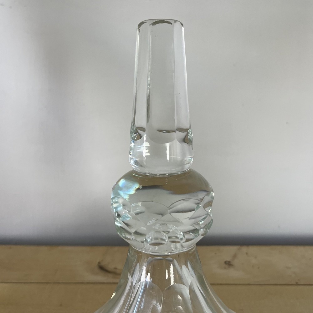 A clear cut glass Edwardian apothecary jar with a pointed finial lid, lattice shoulder pattern, and printed crest above the text ROWAN. View X