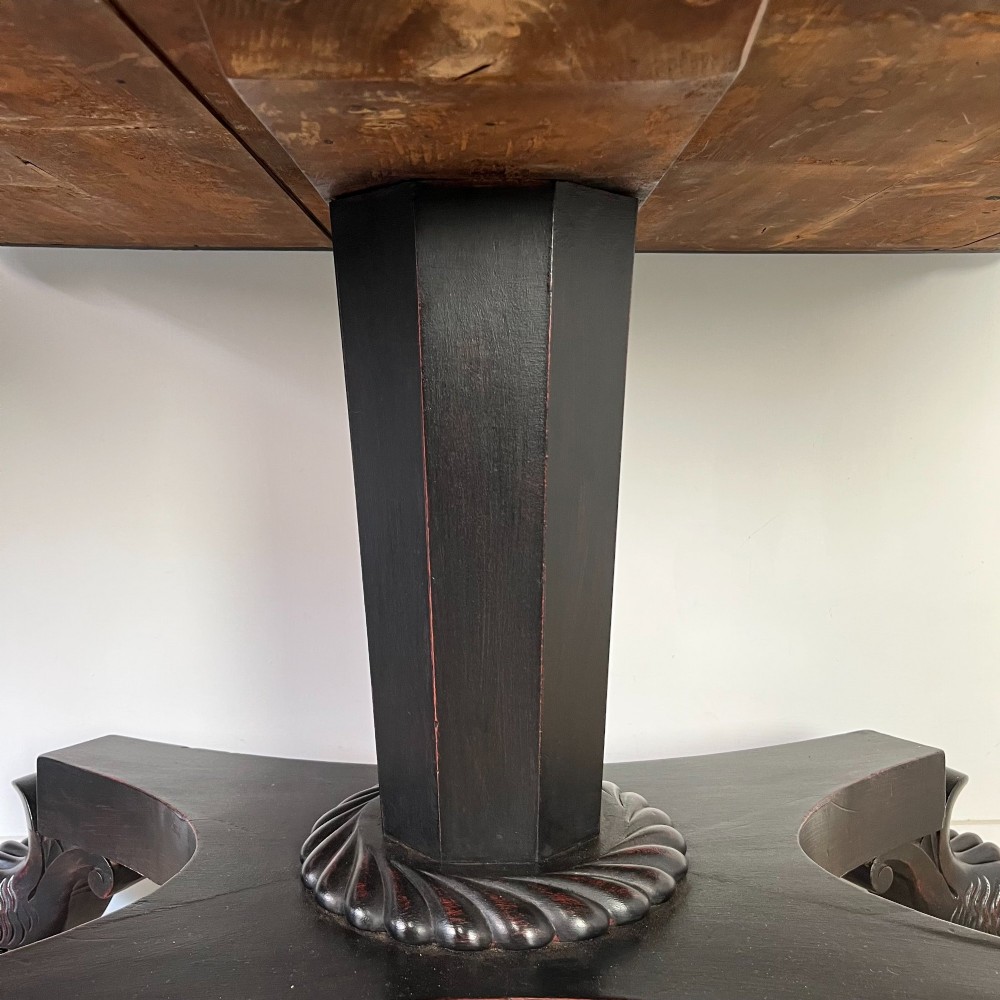 A pair of William IV ebonised mahogany console tables with polished mahogany tops, central pedestal columns, and carved claw feet on brass castors. View X