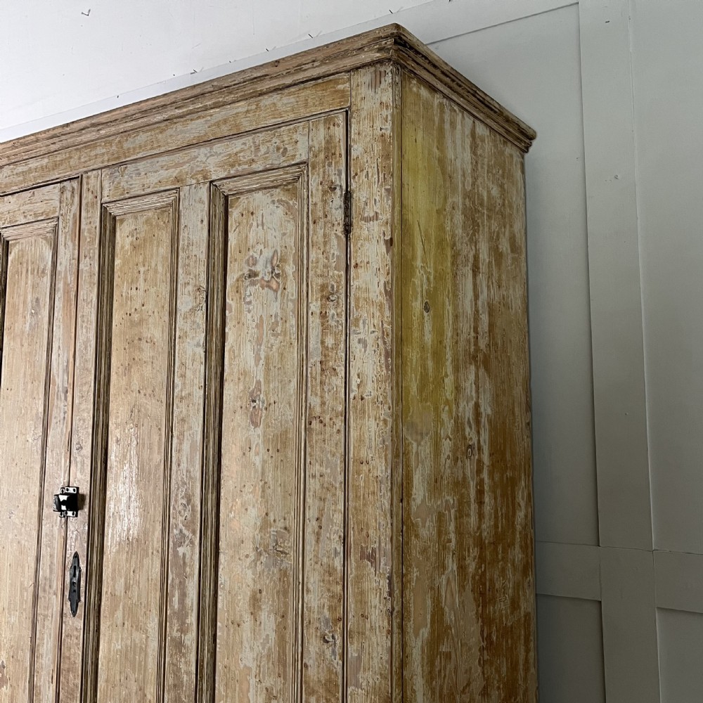 A tall Victorian pine housekeepers cupboard with distressed cream painted finish, double panelled doors, and two bottom drawers. View IX