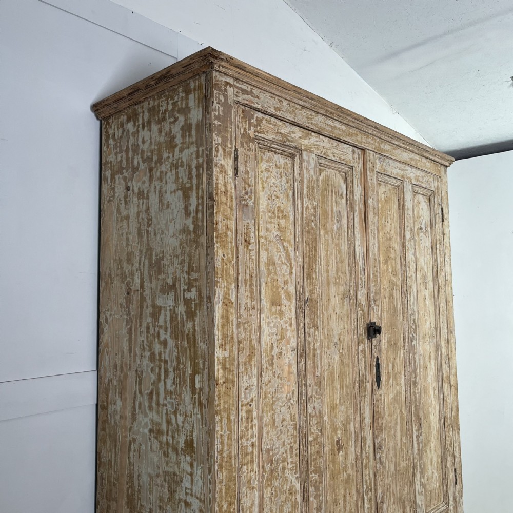 A tall Victorian pine housekeepers cupboard with distressed cream painted finish, double panelled doors, and two bottom drawers. View XI