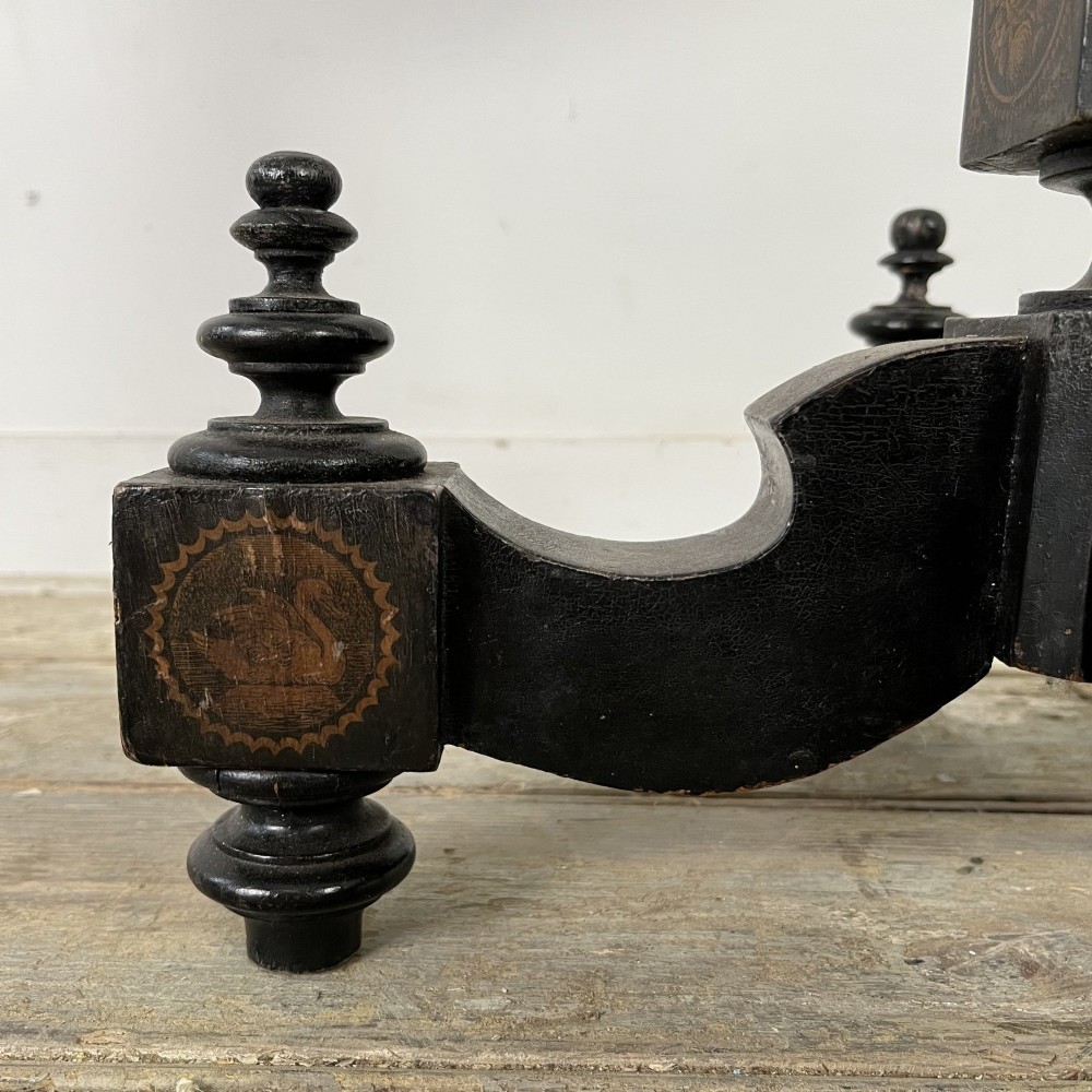 An early nineteenth-century octagonal ebonised tilt-top table featuring intricate ink-drawn classical figures and floral penwork borders. View XIII