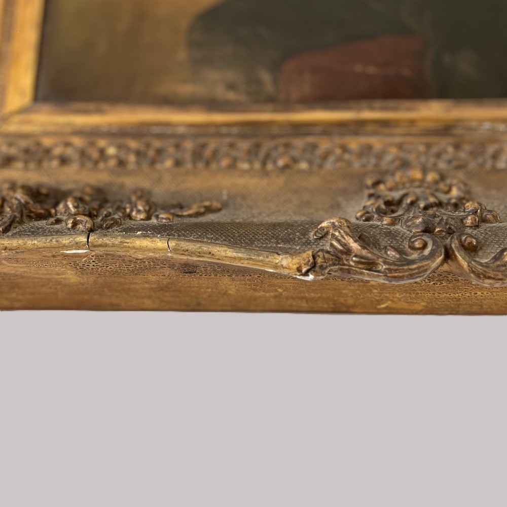A 19th-century oil portrait depicting a seated gentleman in dark attire against a dark background, set within a heavily carved giltwood frame. View XIV