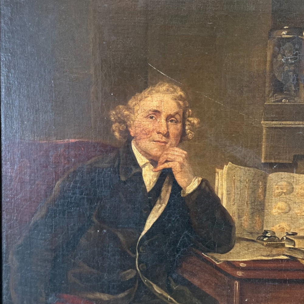 A nineteenth-century oil portrait depicting a seated gentleman resting his chin on his hand, presented in an elaborate gilded swept frame. View II