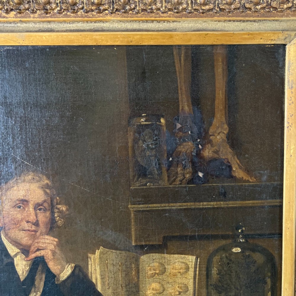 A nineteenth-century oil portrait depicting a seated gentleman resting his chin on his hand, presented in an elaborate gilded swept frame. View IV