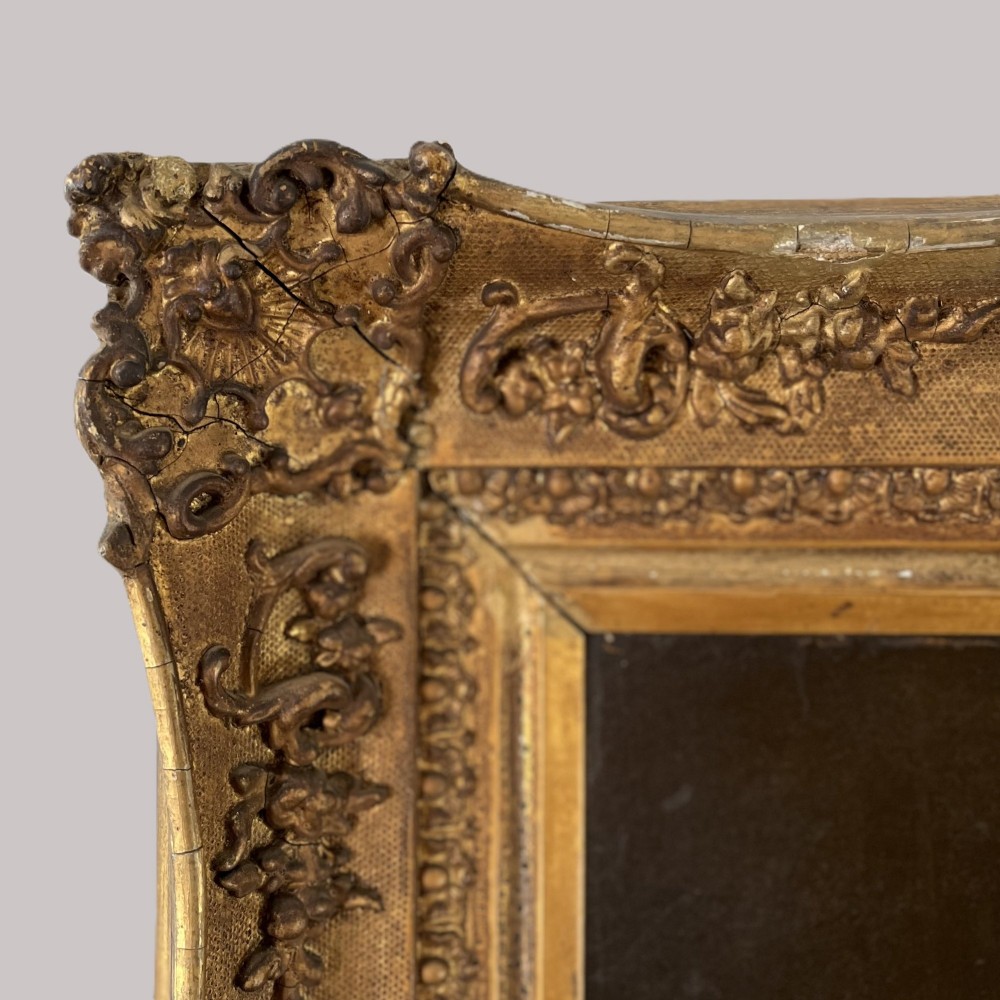 A nineteenth-century oil portrait depicting a seated gentleman resting his chin on his hand, presented in an elaborate gilded swept frame. View V