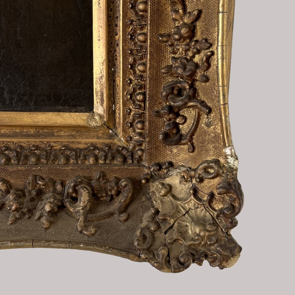A nineteenth-century oil portrait depicting a seated gentleman resting his chin on his hand, presented in an elaborate gilded swept frame. View VII