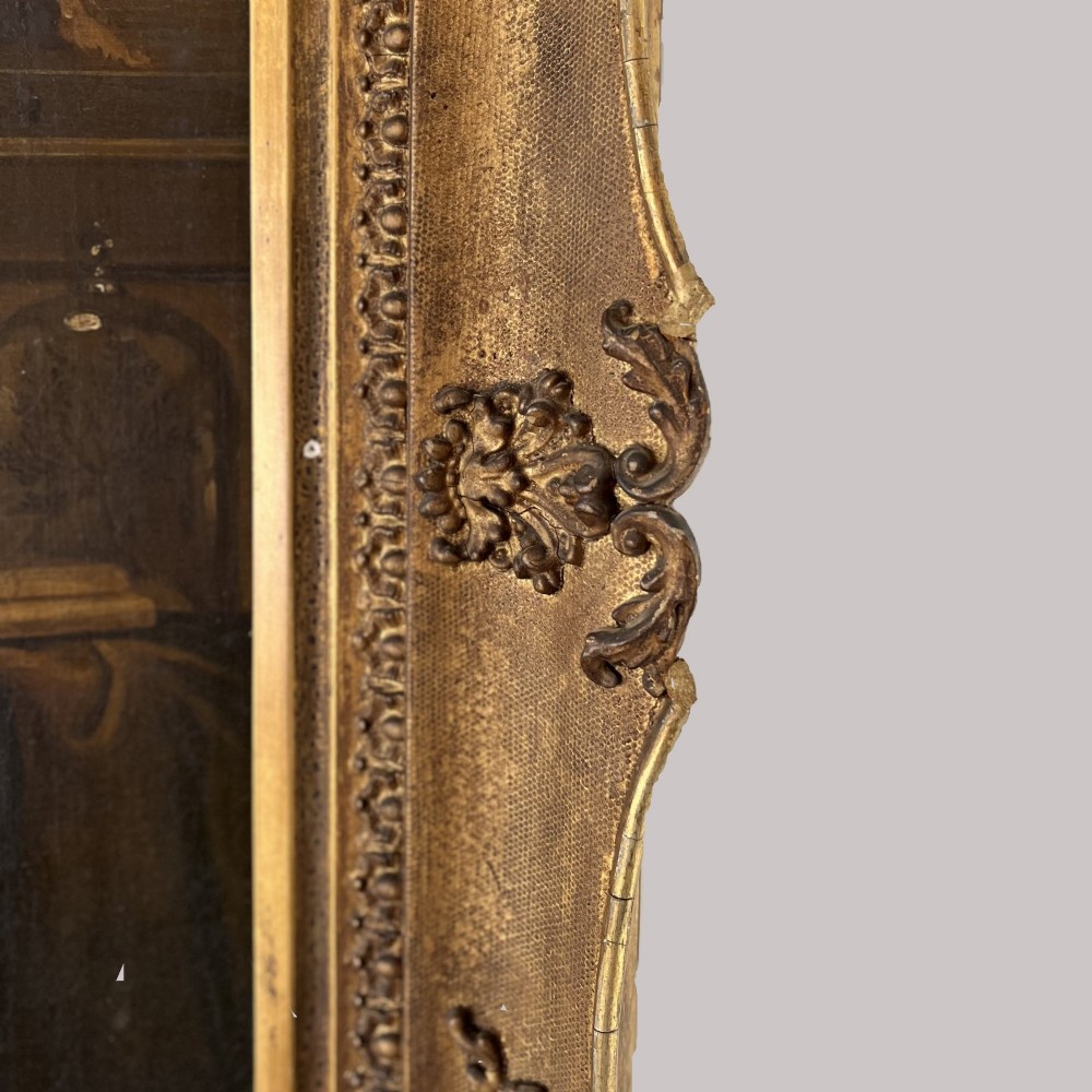 A nineteenth-century oil portrait depicting a seated gentleman resting his chin on his hand, presented in an elaborate gilded swept frame. View VIII