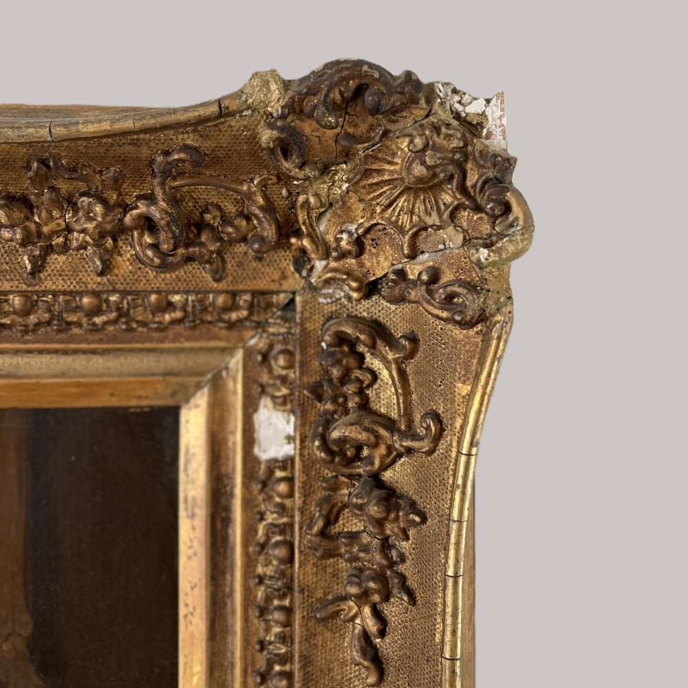 A nineteenth-century oil portrait depicting a seated gentleman resting his chin on his hand, presented in an elaborate gilded swept frame. View IX