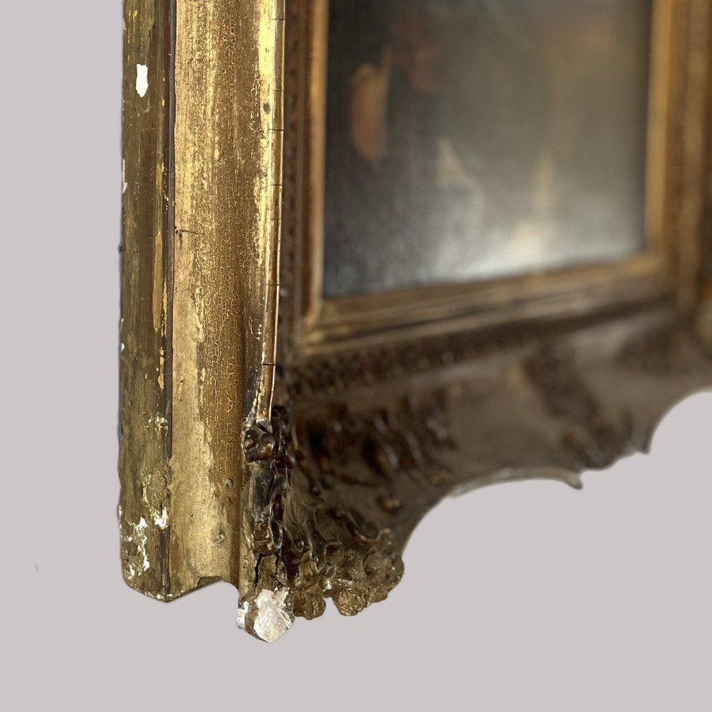 A nineteenth-century oil portrait depicting a seated gentleman resting his chin on his hand, presented in an elaborate gilded swept frame. View X