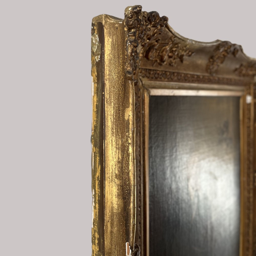 A nineteenth-century oil portrait depicting a seated gentleman resting his chin on his hand, presented in an elaborate gilded swept frame. View XI
