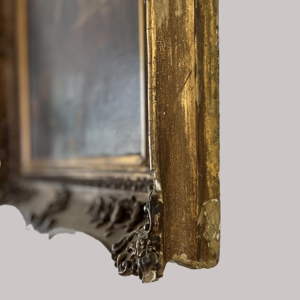 A nineteenth-century oil portrait depicting a seated gentleman resting his chin on his hand, presented in an elaborate gilded swept frame. View XII