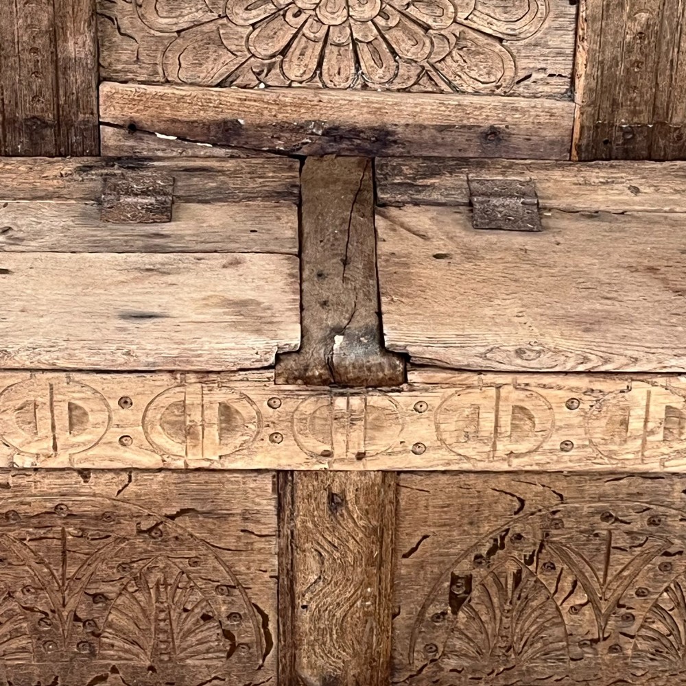 An early nineteenth-century carved oak high-back settle featuring carved back panels, curved arms, and an integrated box storage seat. View XIV