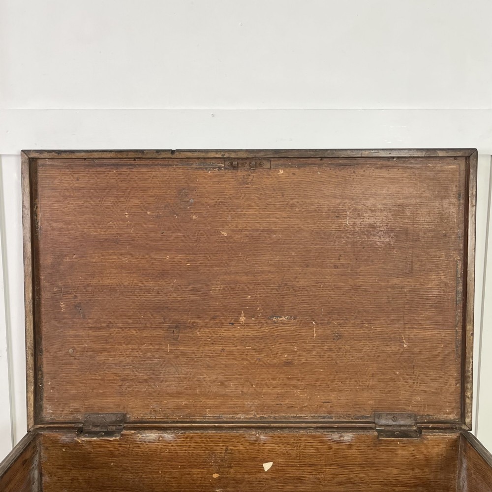 An early 20th-century pine carpenters chest featuring an upper hinged lid and multiple shallow lower drawers with small round knobs. View V