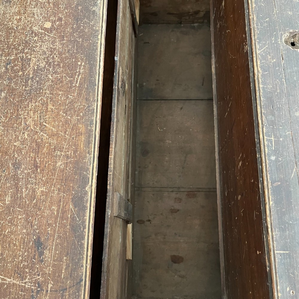 An early 20th-century pine carpenters chest featuring an upper hinged lid and multiple shallow lower drawers with small round knobs. View VI