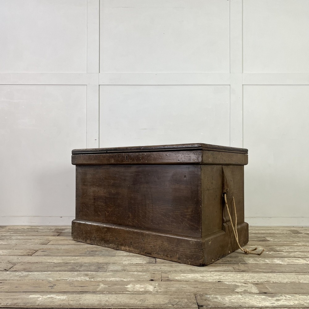 An early 20th-century pine carpenters chest featuring an upper hinged lid and multiple shallow lower drawers with small round knobs. View IX